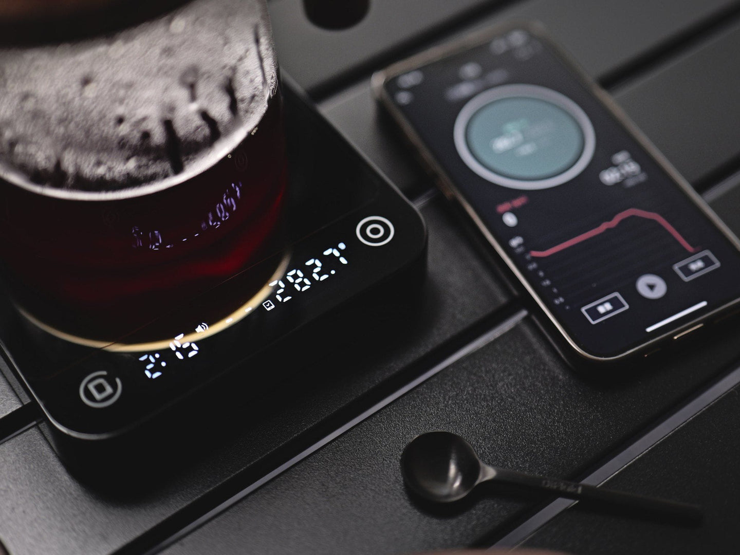 DiFluid Microbalance Ti weighing a pour-over brew next to the DiFluid Café app
