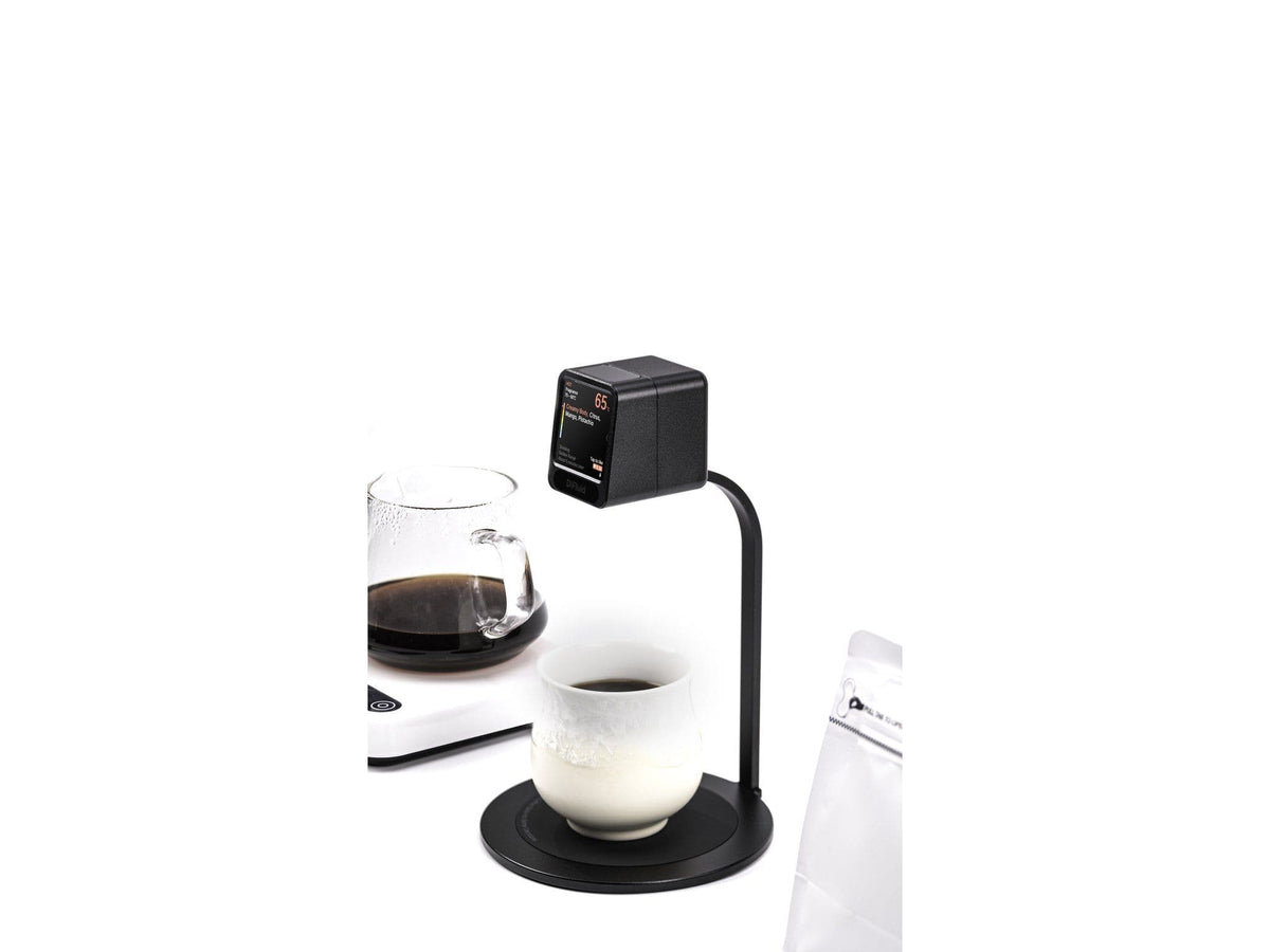 DiFluid Moment with a cup and carafe of brewed coffee