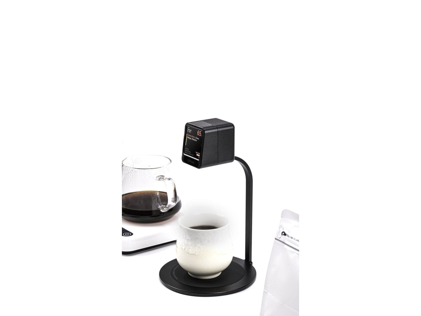 DiFluid Moment with a cup and carafe of brewed coffee